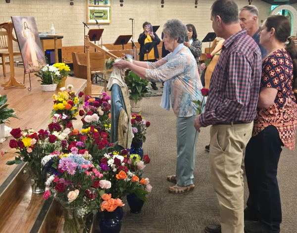 Parishioner Patsy Pantleo places a wreath on the Virgin Mary during the 2025 May Crowning Mass at St. Joseph Church 